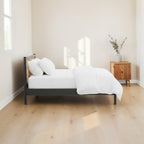 Homecrest Wicker solid mango wood bed frame with a natural handwoven rattan headboard in a minimalist bedroom