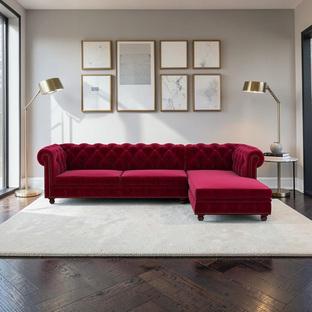 Homecrest Wardour L-shaped burgundy velvet Chesterfield sofa with tufted back and brass nailhead trim in a living room