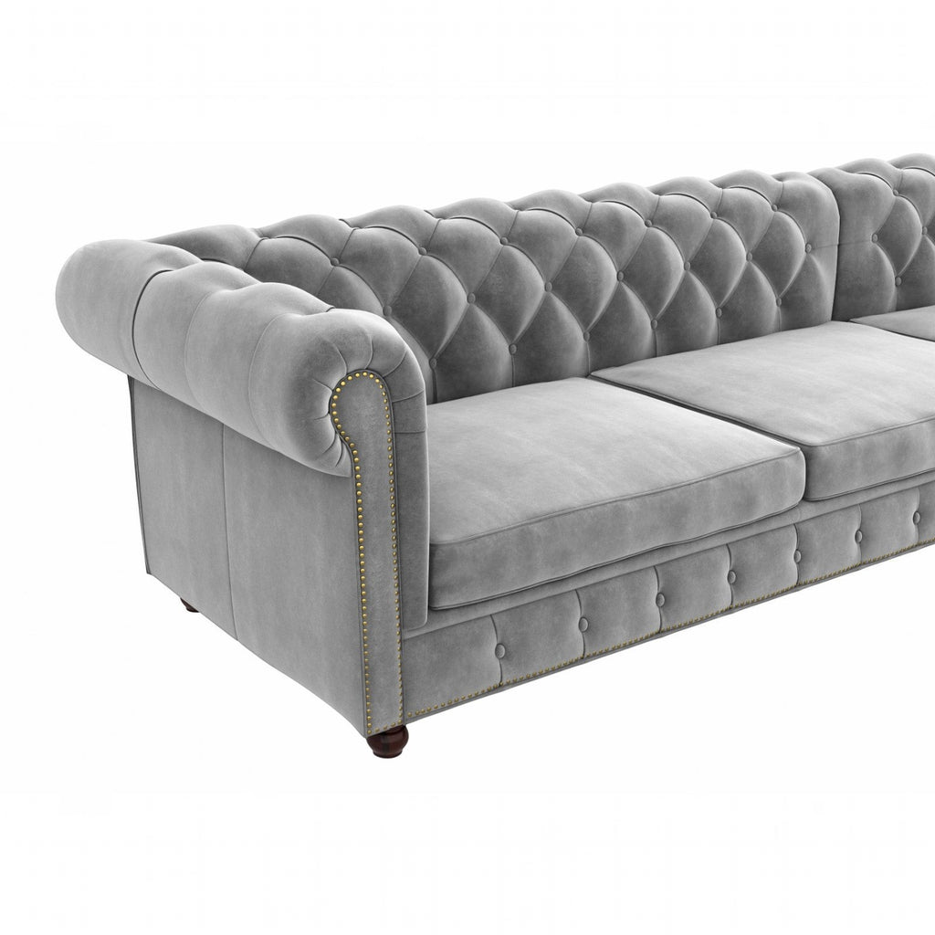 Homecrest Wardour L-shape grey velvet Chesterfield sofa with tufted backrest and brass nailhead trim
