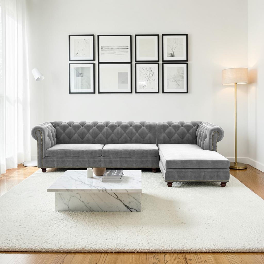 Homecrest Wardour L-shaped grey velvet Chesterfield sofa with tufted detailing and nailhead trim in a modern living room