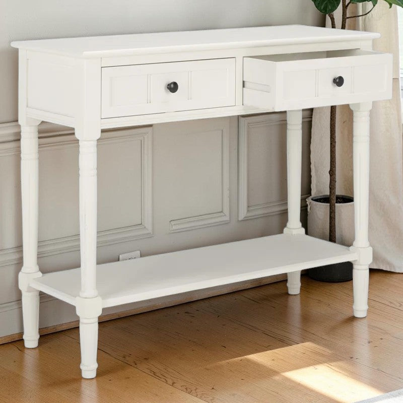 Homecrest Winsley white console table made of sheesham wood with carved legs, two drawers, and a lower shelf.