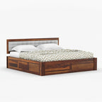 Homecrest Thurloe solid Sheesham wood bed featuring a tufted grey cushioned headboard and natural wood grain finish.