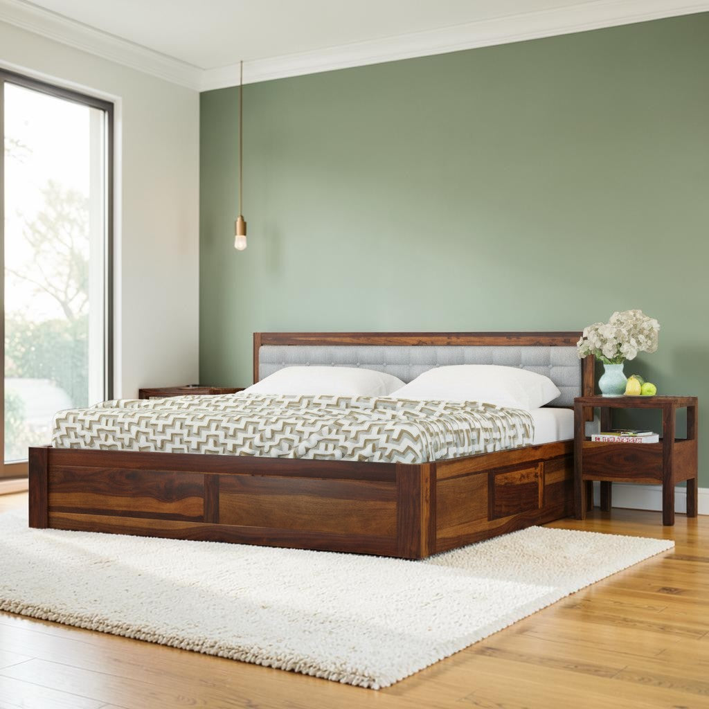 Homecrest Thurloe solid Sheesham wood bed featuring a grey cushioned headboard and integrated storage in a bedroom