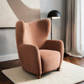 Homecrest Yannick wing-arm accent chair in plush truffle pink velvet with dark turned wooden feet in a modern room.